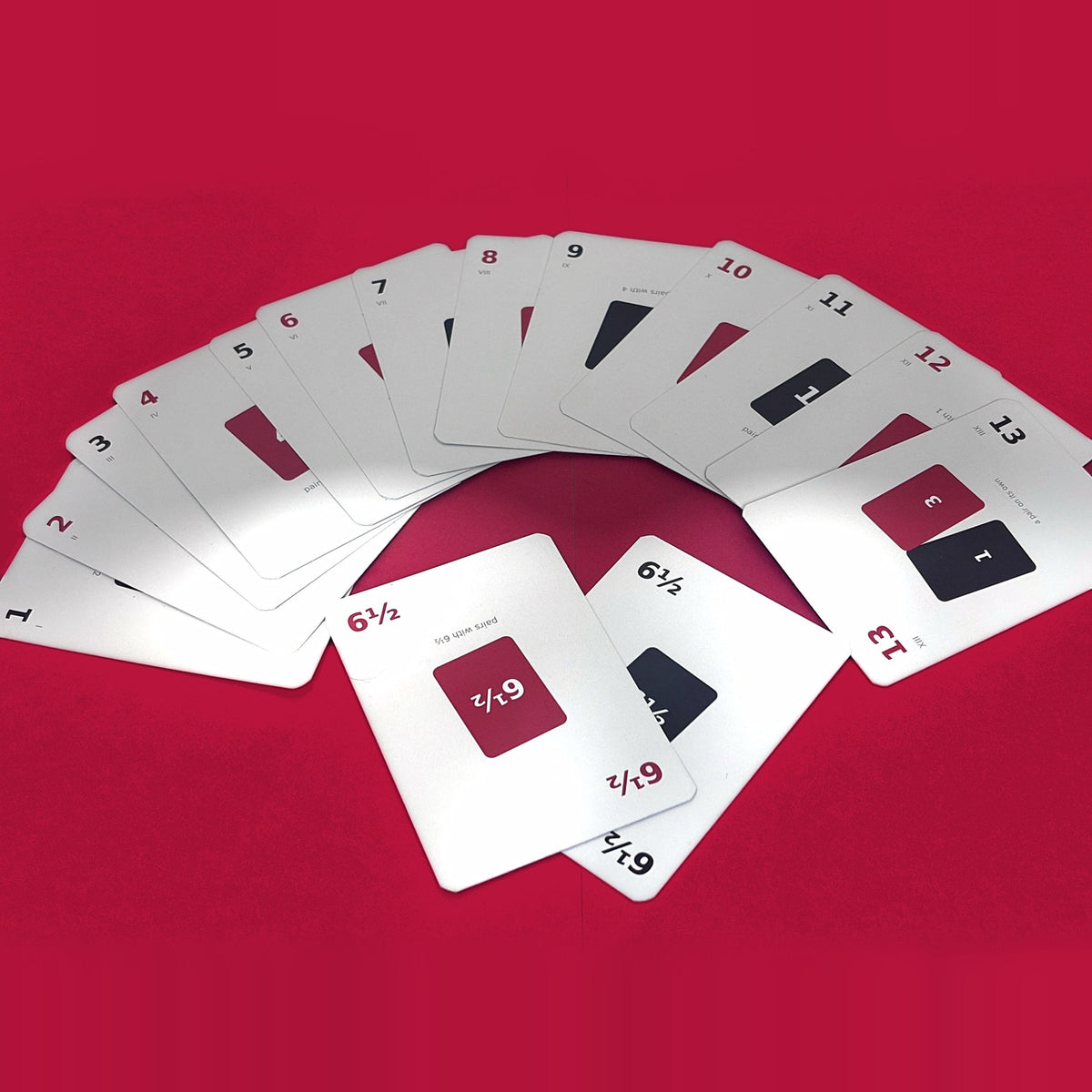 THIRTEEN playing cards fanned out showing numbers 1 to 13 and two 6 and a half cards